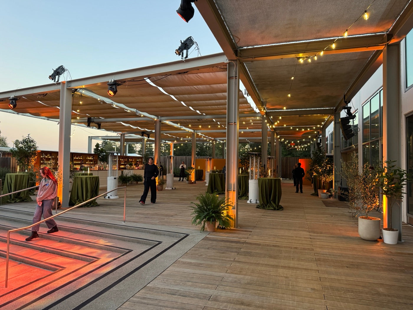 Planted promenade lining an open-air event deck